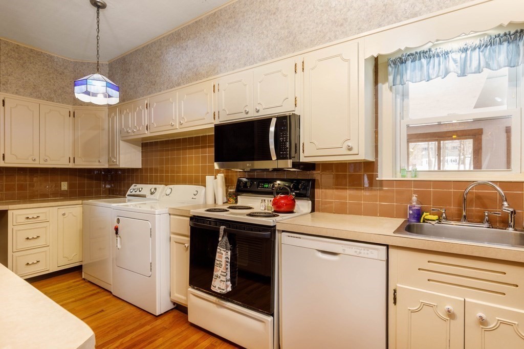 196 Chestnut Street Gardner, MA 01440 - Photo 2 of 30 a kitchen with stainless steel appliances granite countertop a sink a stove a microwave a refrigerator and cabinets