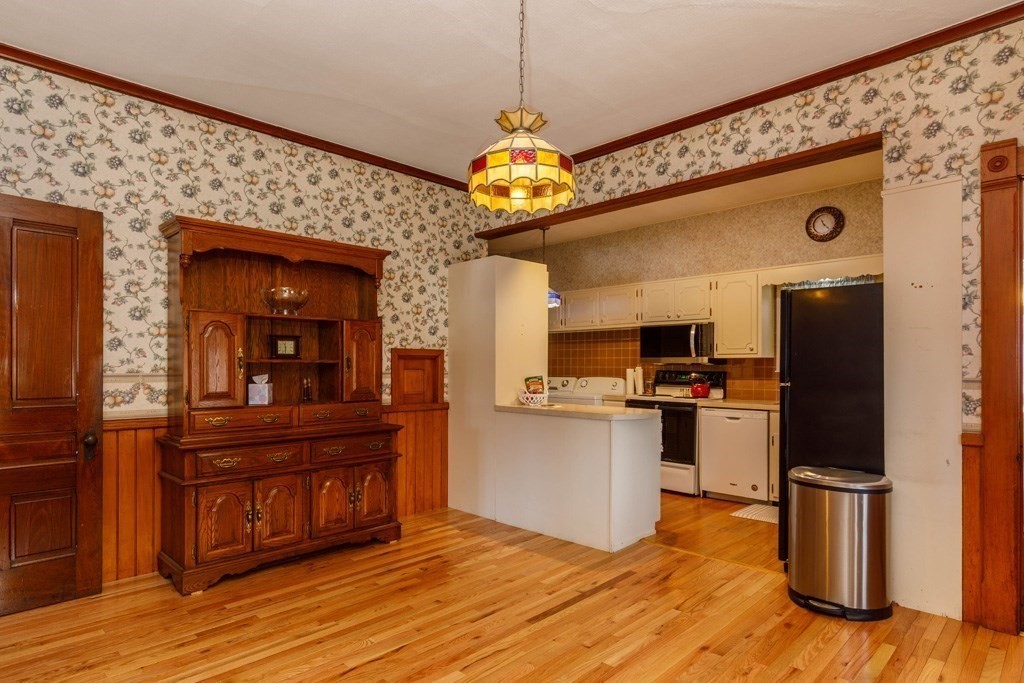 196 Chestnut Street Gardner, MA 01440 - Photo 3 of 30 a kitchen view with wooden floor and a refrigerator