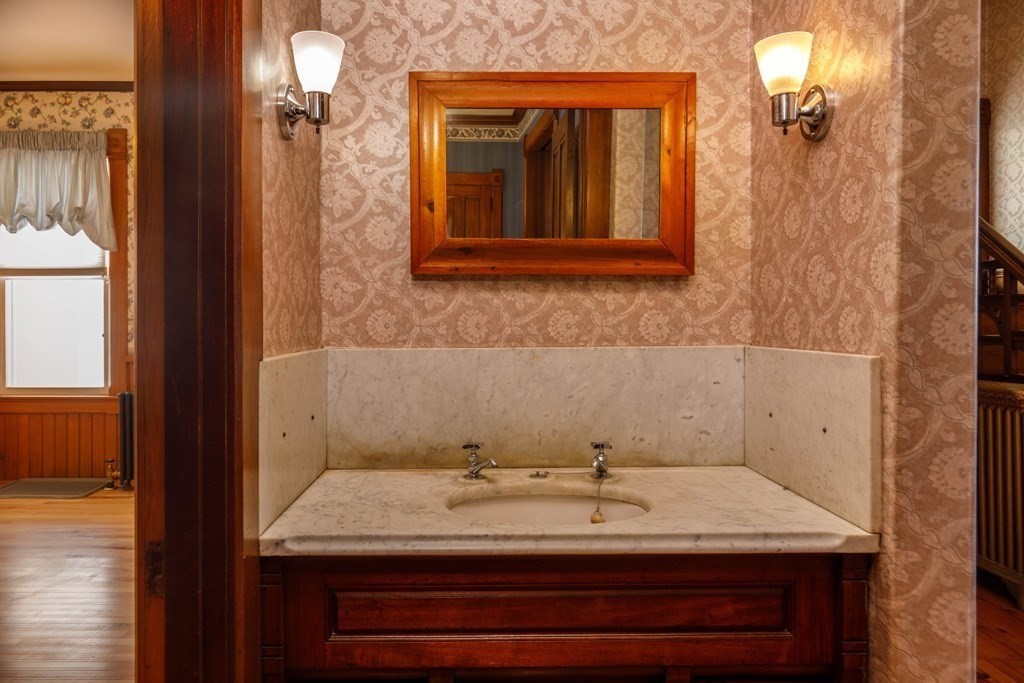196 Chestnut Street Gardner, MA 01440 - Photo 10 of 30 a bathroom with a granite countertop sink and a mirror