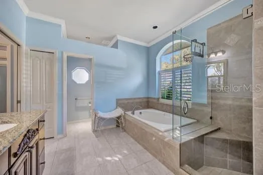 a bathroom with a tub a toilet and a shower