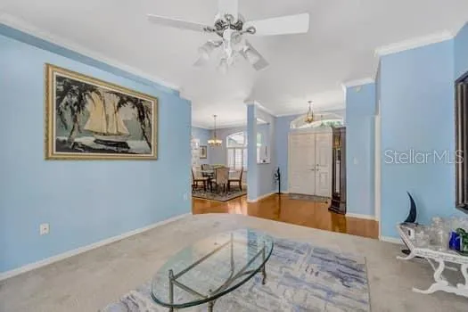 a spacious bedroom with a large bed and a chandelier