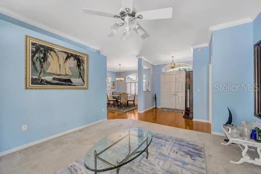 507 Surrey Lane Lutz, FL 33549 - Photo 18 of 27 a spacious bedroom with a large bed and a chandelier