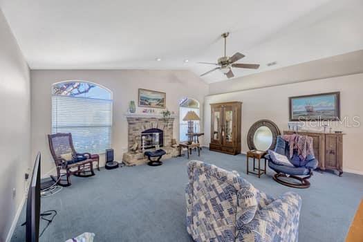 507 Surrey Lane Lutz, FL 33549 - Photo 19 of 27 a living room with furniture a fireplace and white walls