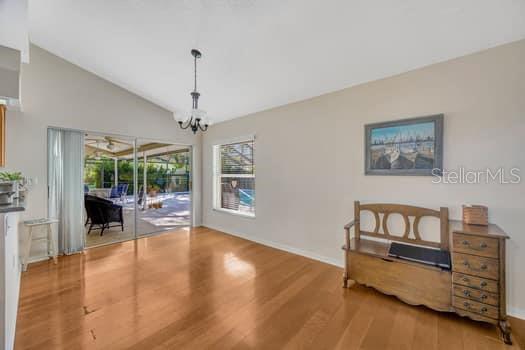 507 Surrey Lane Lutz, FL 33549 - Photo 23 of 27 a living room with furniture and a chandelier