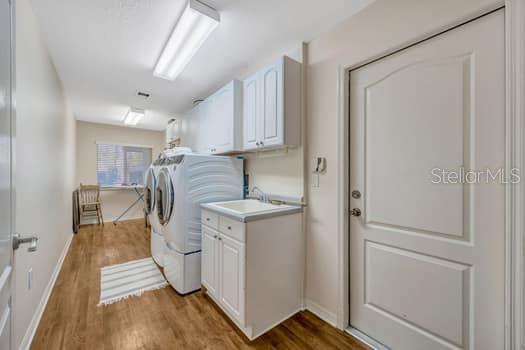 507 Surrey Lane Lutz, FL 33549 - Photo 24 of 27 a kitchen with white cabinets and white appliances