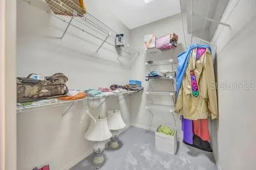 a room with a white bath tub and cabinets