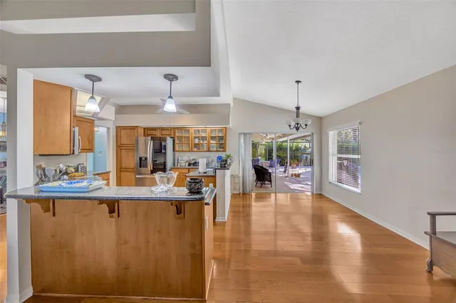 a living room with fireplace furniture and a large window