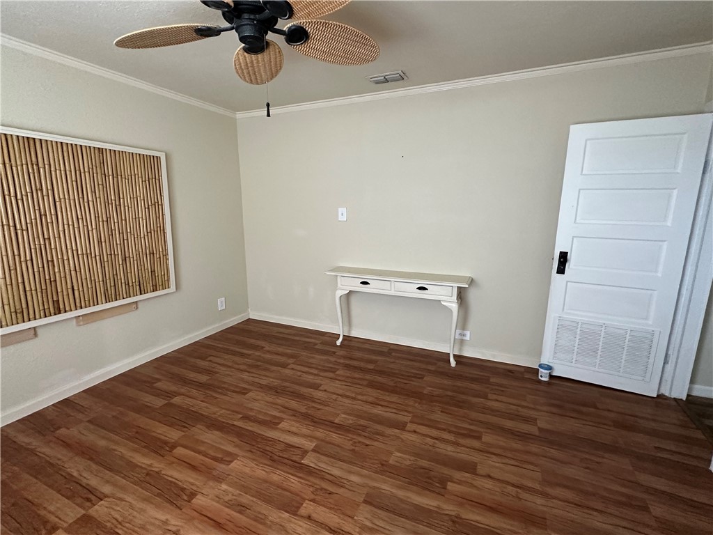 230 Lola Johnson Road Corpus Christi, TX 78418 - Photo 11 of 40 a view of an empty room with a window and wooden floor