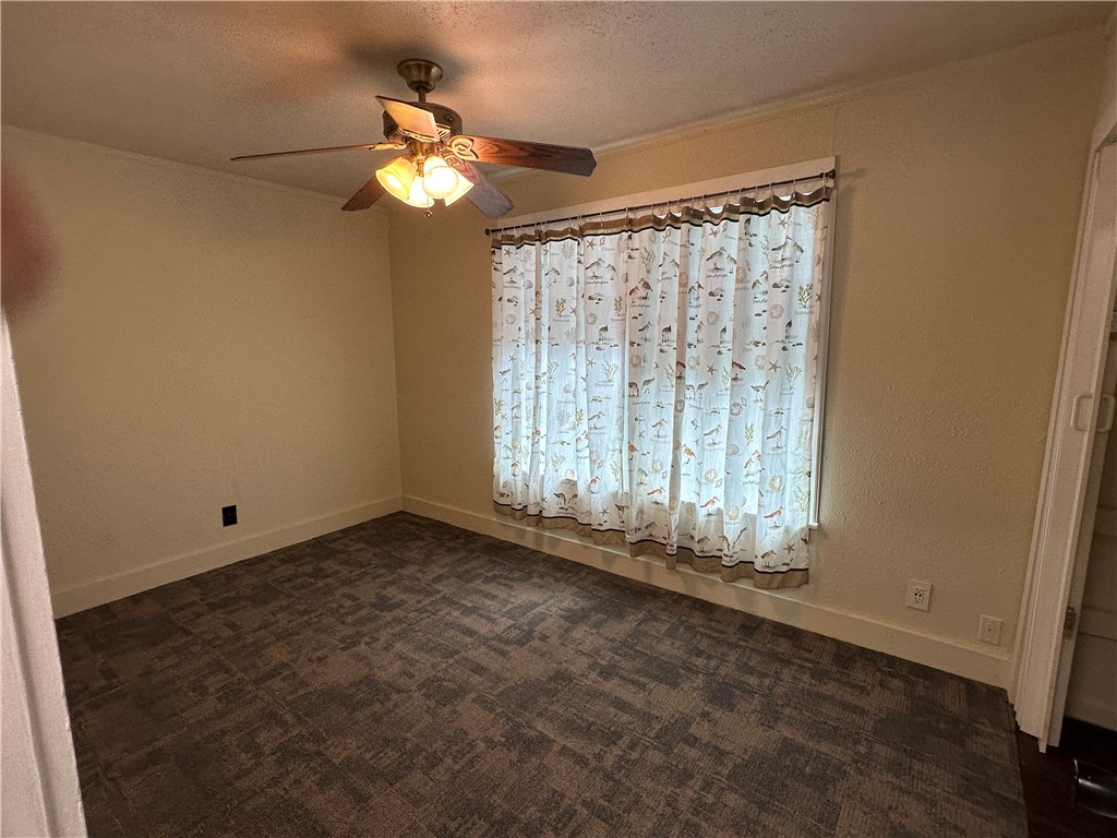 230 Lola Johnson Road Corpus Christi, TX 78418 - Photo 20 of 40 an empty room with chandelier fan and windows