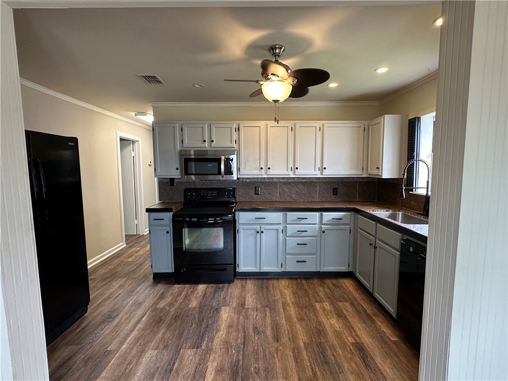 230 Lola Johnson Road Corpus Christi, TX 78418 - Photo 23 of 40 a kitchen with a refrigerator and a stove top oven