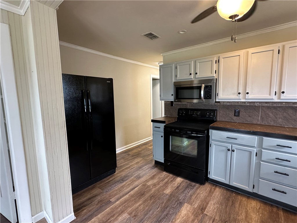 230 Lola Johnson Road Corpus Christi, TX 78418 - Photo 24 of 40 a kitchen with white cabinets and appliances