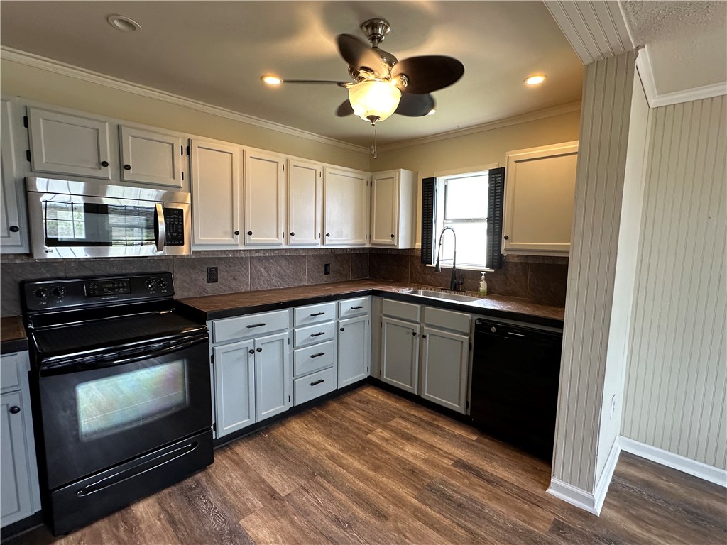 230 Lola Johnson Road Corpus Christi, TX 78418 - Photo 25 of 40 a kitchen with stainless steel appliances granite countertop a stove a sink and a microwave