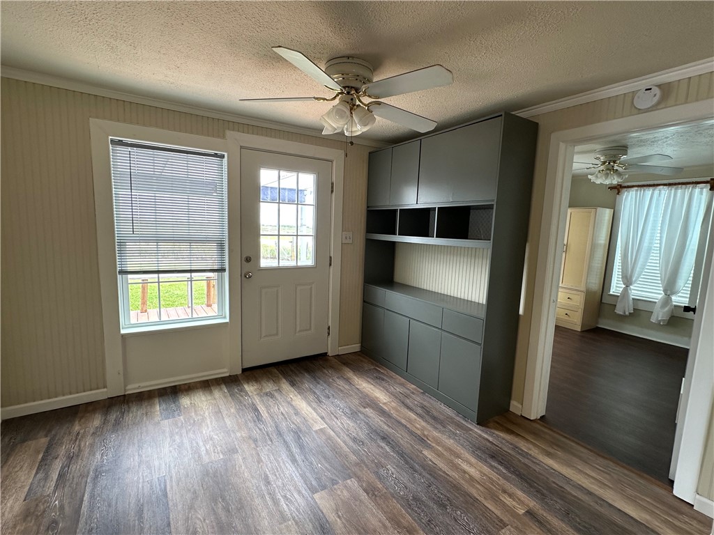230 Lola Johnson Road Corpus Christi, TX 78418 - Photo 27 of 40 a view of an empty room with a window and wooden floor