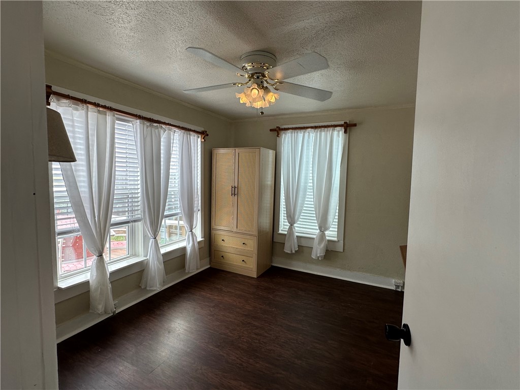 230 Lola Johnson Road Corpus Christi, TX 78418 - Photo 28 of 40 an empty room with wooden floor fan and windows