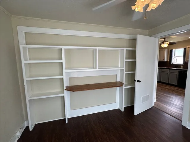 a view of a room with wooden floors and cabinet