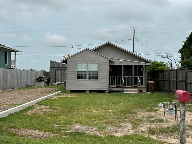a view of a house with a yard and sitting area