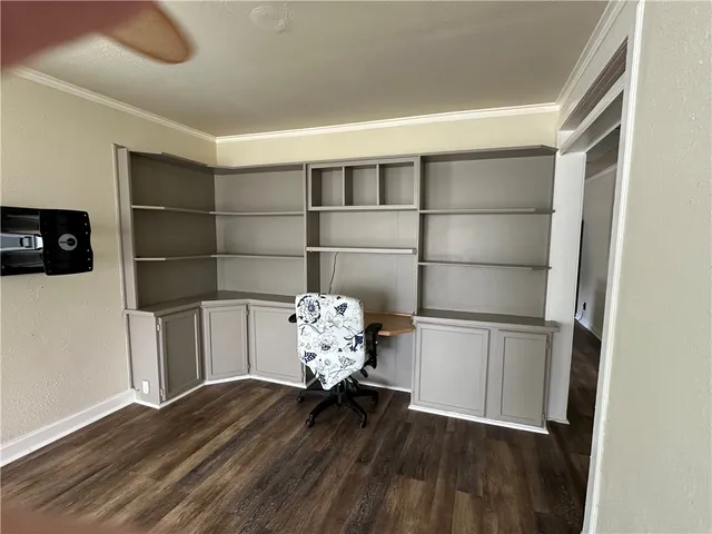 a room with wooden floor and shelf