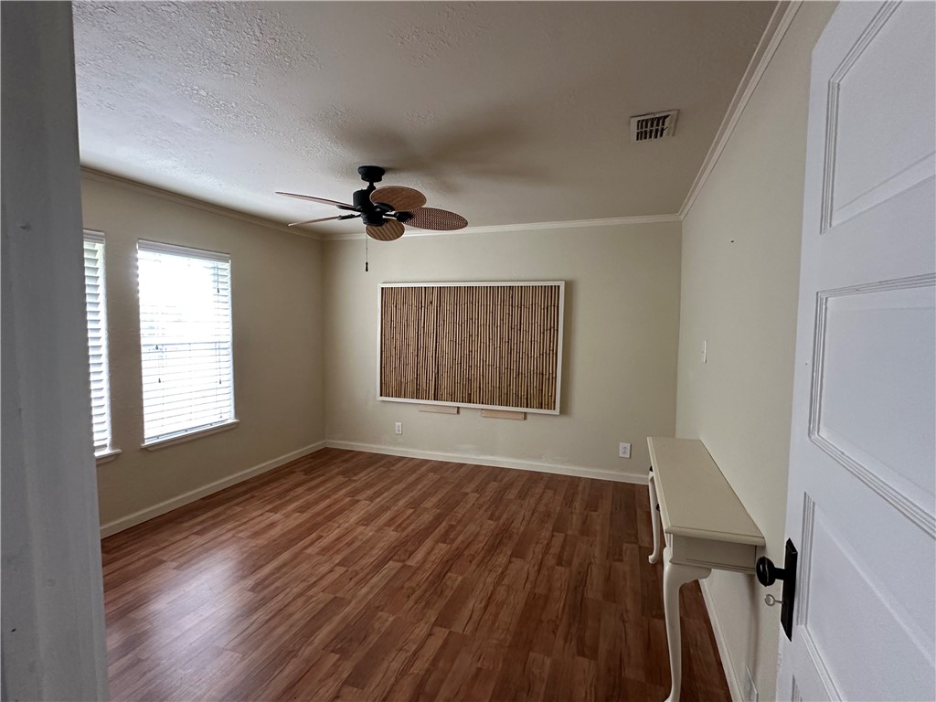 230 Lola Johnson Road Corpus Christi, TX 78418 - Photo 10 of 40 a view of an empty room with a window and wooden floor