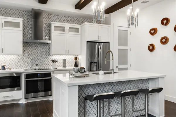 a kitchen with stainless steel appliances a sink stove and refrigerator