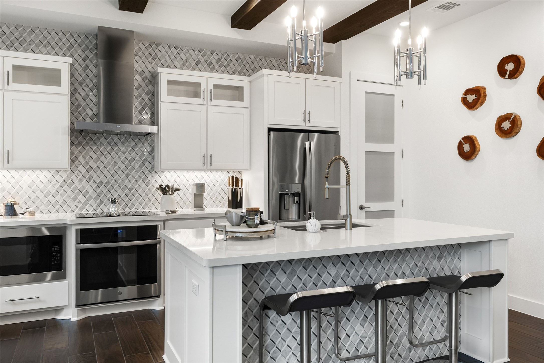 408 Rose Branch Way, Unit 24 Austin, TX 78738 - Photo 11 of 39 Kitchen featuring stainless steel appliances, wall chimney range hood, a breakfast bar, wood tiled floors, and tasteful backsplash