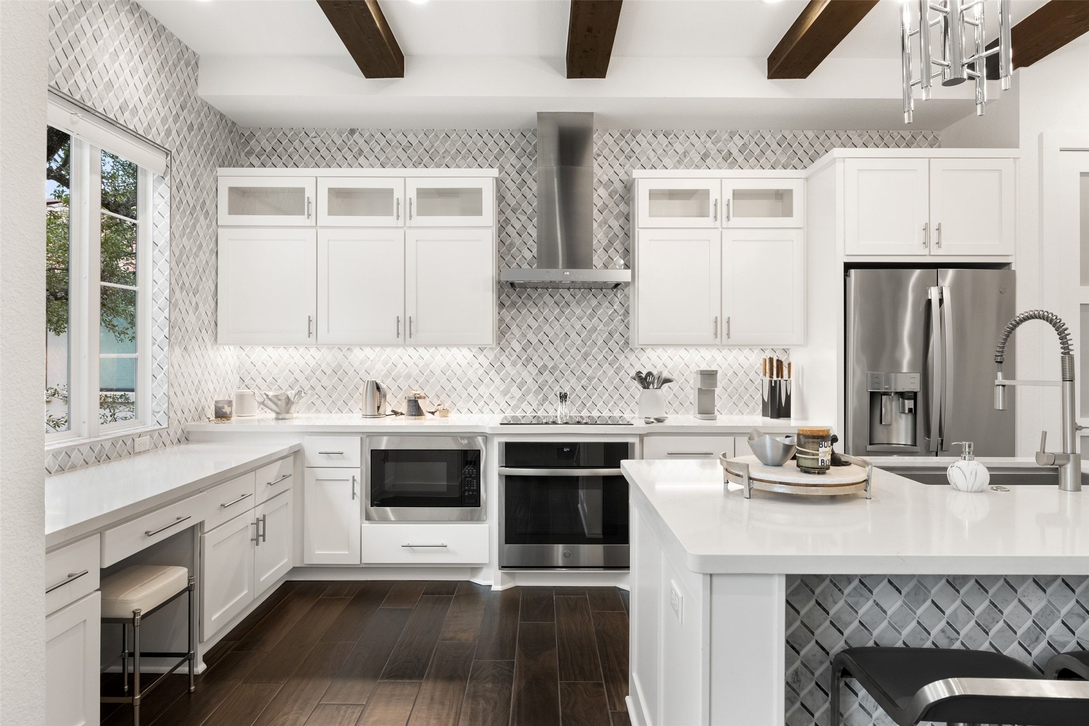 408 Rose Branch Way, Unit 24 Austin, TX 78738 - Photo 12 of 39 Kitchen with white cabinets, stainless steel appliances, wall chimney exhaust hood, dark wood-style flooring, and glass insert cabinets