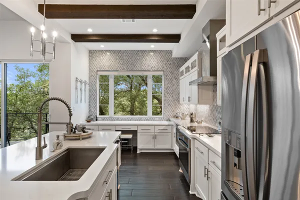 a kitchen with a sink stove and refrigerator