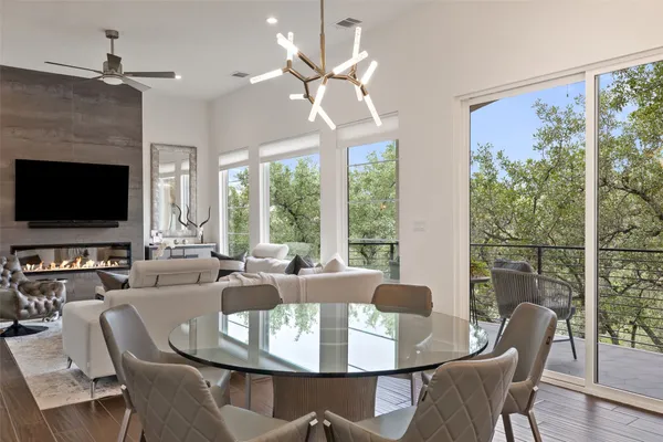 a dining room with furniture a flat screen tv and a large window