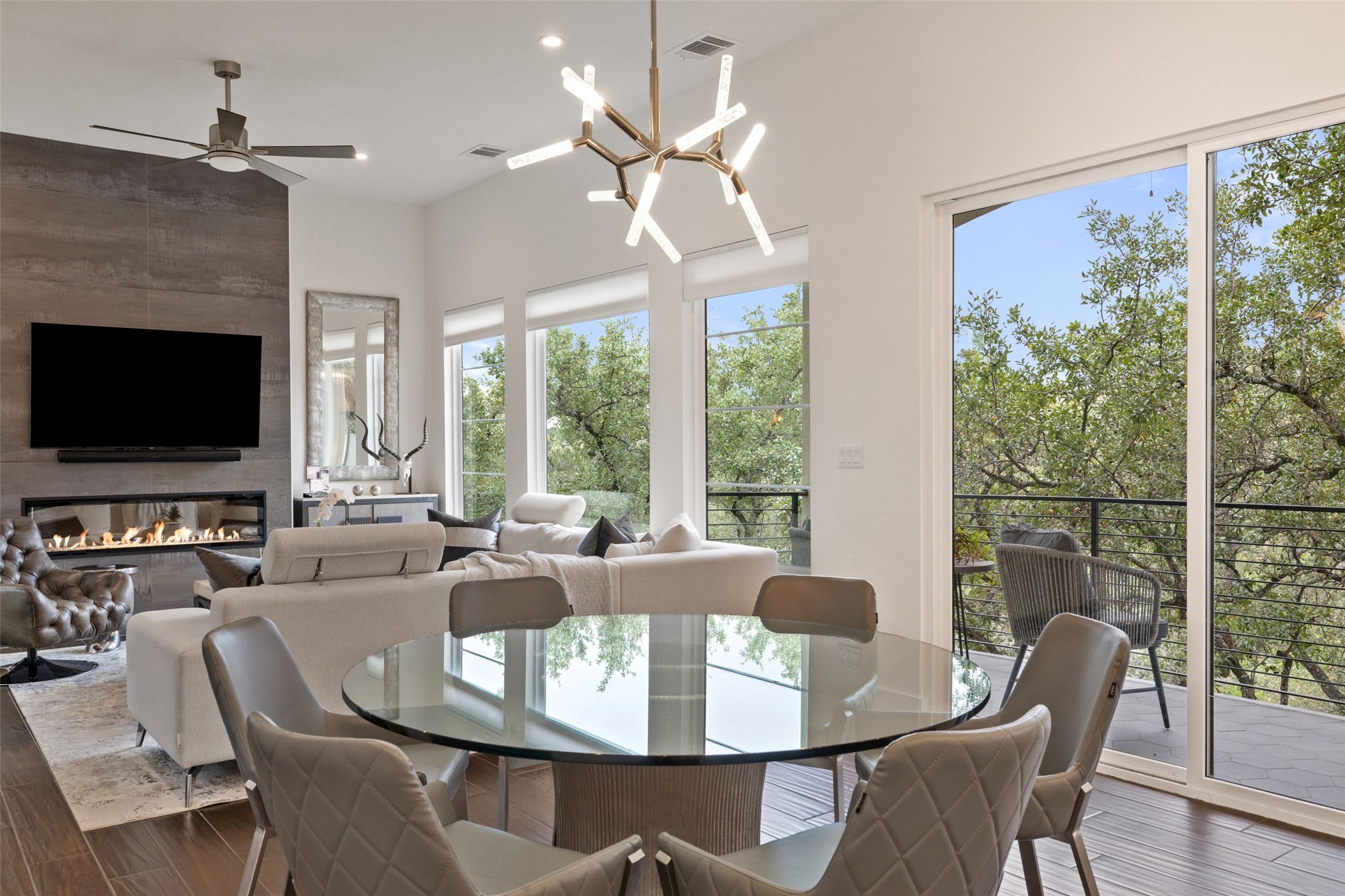 408 Rose Branch Way, Unit 24 Austin, TX 78738 - Photo 17 of 39 Dining space with dark wood-type flooring, a chandelier, a fireplace, a ceiling fan, and recessed lighting
