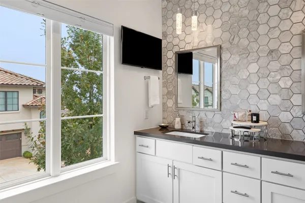 a bathroom with a sink a mirror and a window