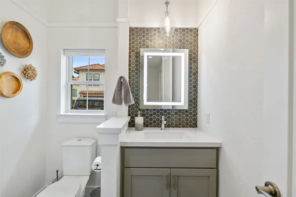 a bathroom with a toilet a sink and a mirror