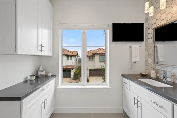 a kitchen with stainless steel appliances granite countertop a sink and a microwave
