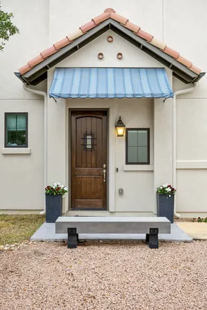 a front view of a house with a garden