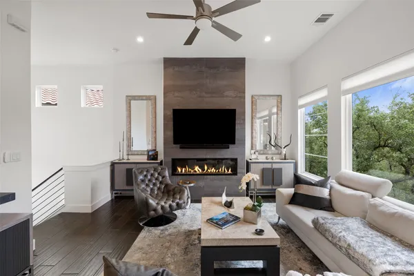 a living room with furniture a large window and a flat screen tv