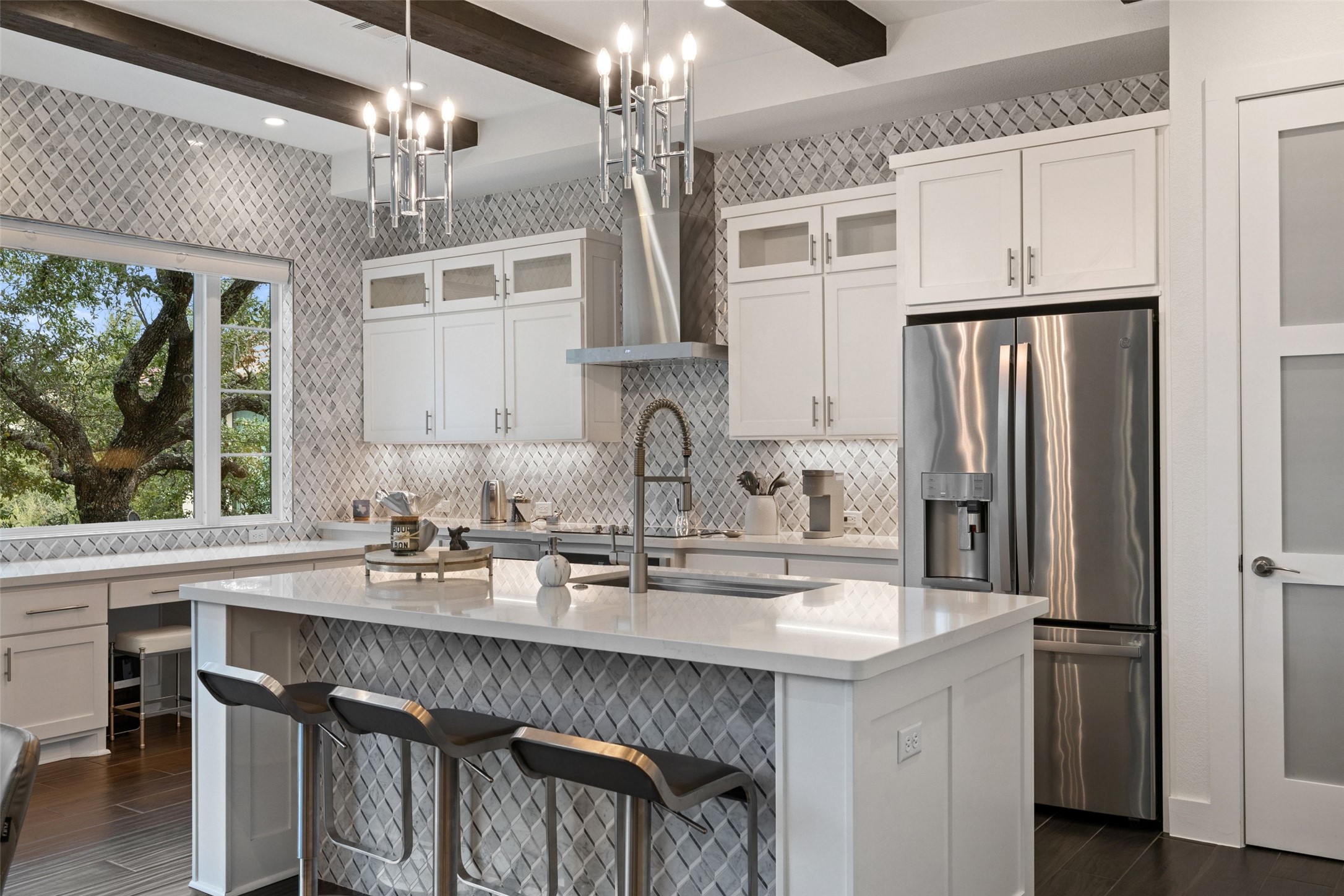 408 Rose Branch Way, Unit 24 Austin, TX 78738 - Photo 9 of 39 Kitchen featuring stainless steel fridge with ice dispenser, beam ceiling, light stone countertops, a breakfast bar, and white cabinetry