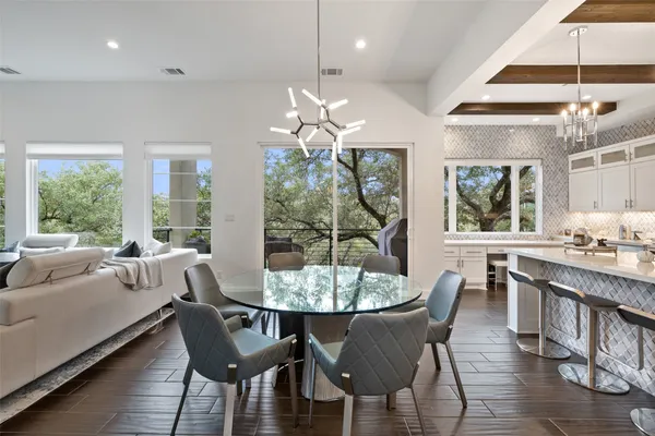 a dining room with furniture a chandelier and window