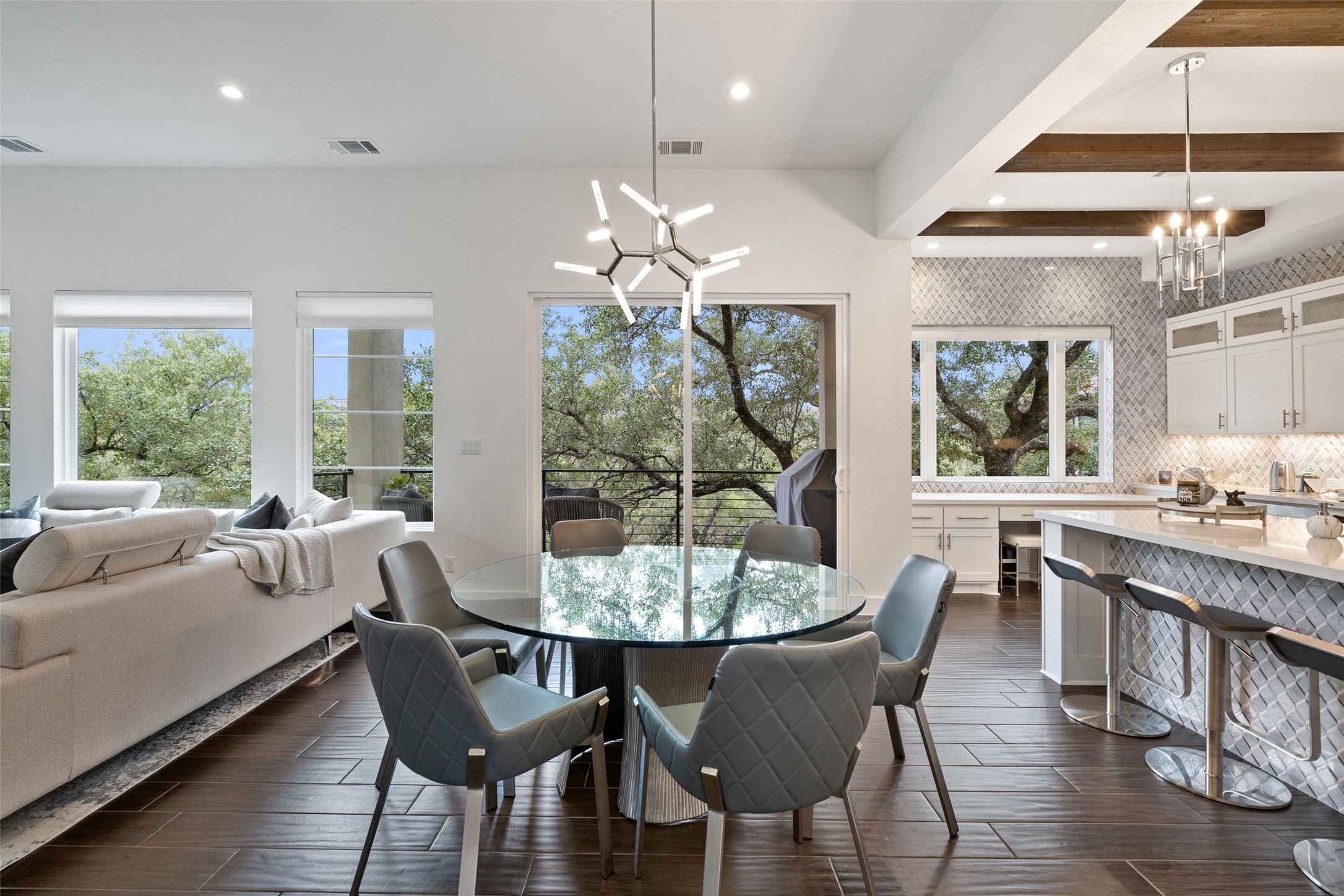 408 Rose Branch Way, Unit 24 Austin, TX 78738 - Photo 10 of 39 Dining area with a chandelier, wood finish floors, recessed lighting, and beamed ceiling