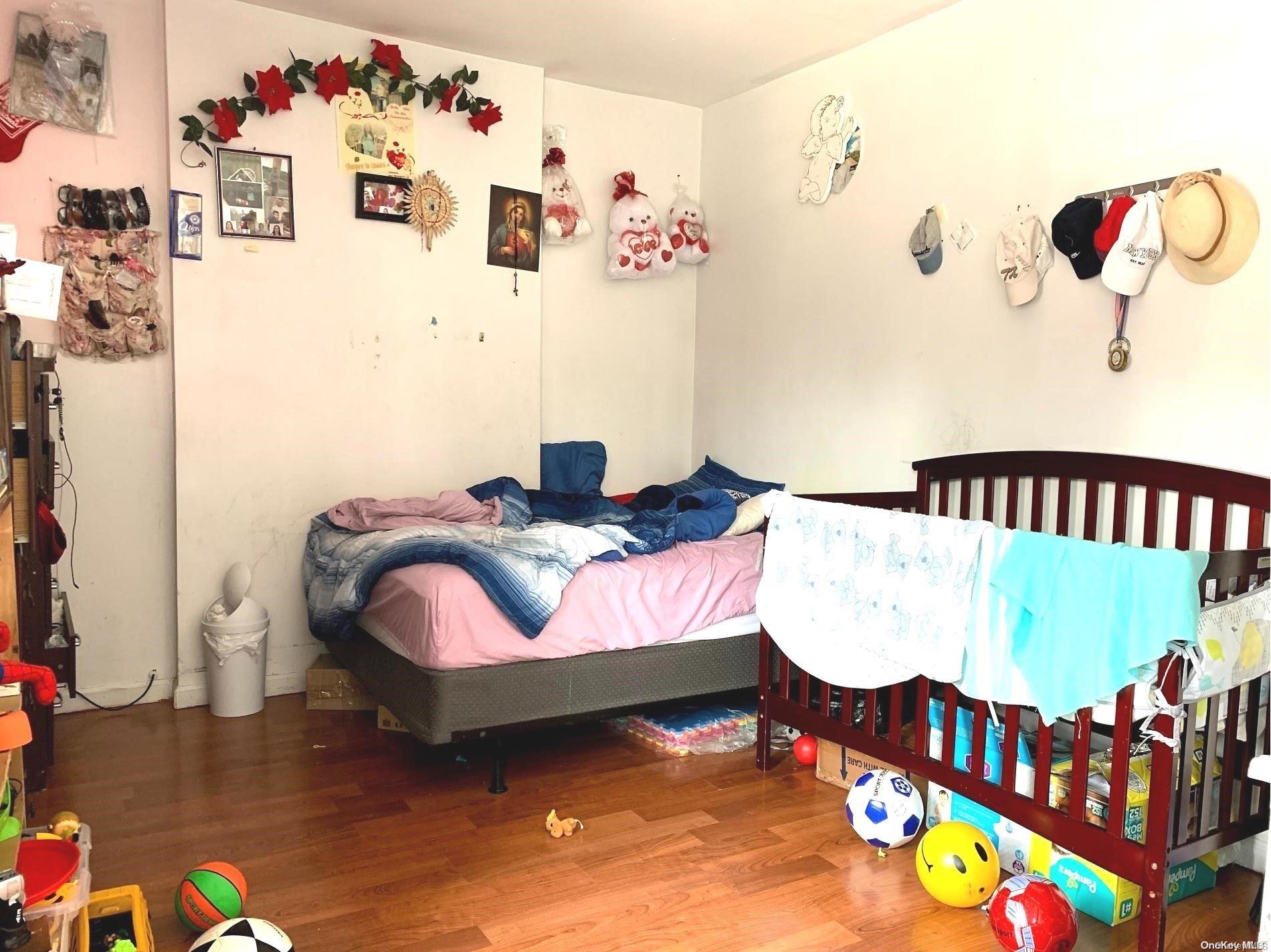 108-13 37th Avenue Queens, NY 11368 - Photo 12 of 23 a bedroom with bed and a couch