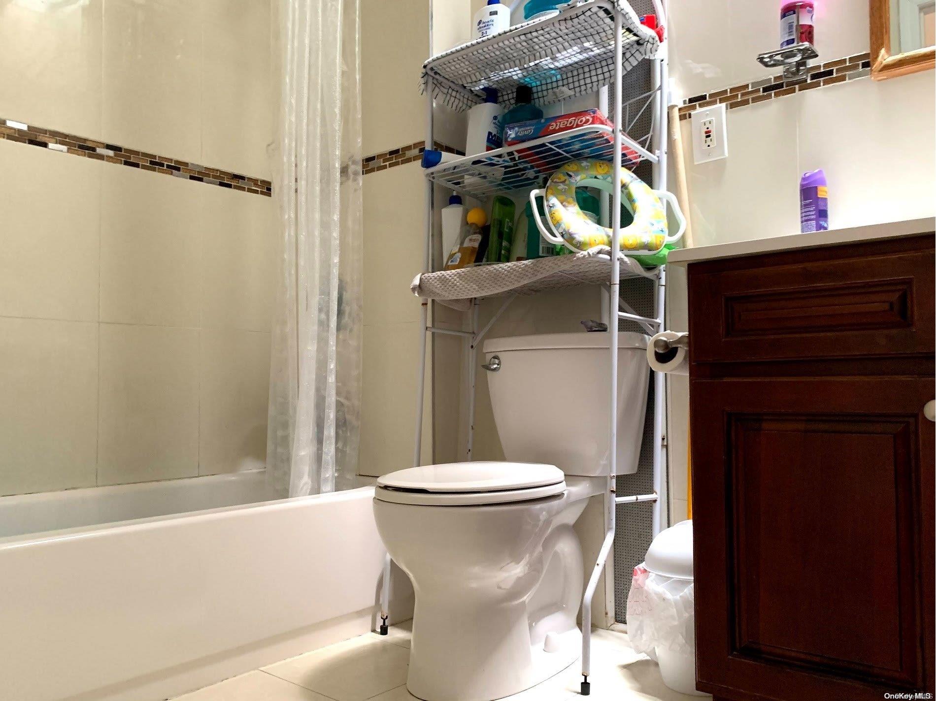 108-13 37th Avenue Queens, NY 11368 - Photo 13 of 23 a bathroom with a sink toilet and shower