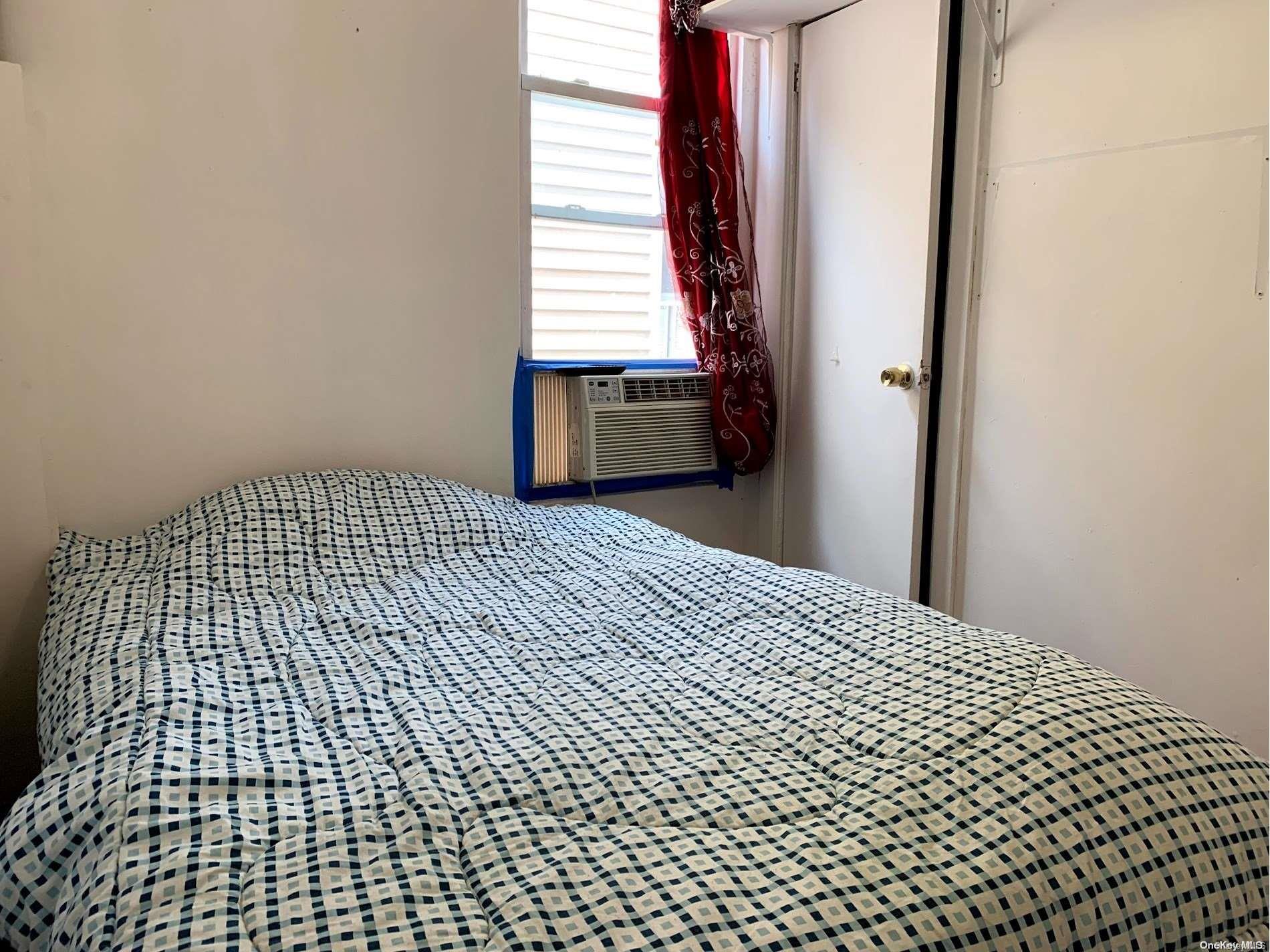 108-13 37th Avenue Queens, NY 11368 - Photo 15 of 23 a bedroom with a bed and a window