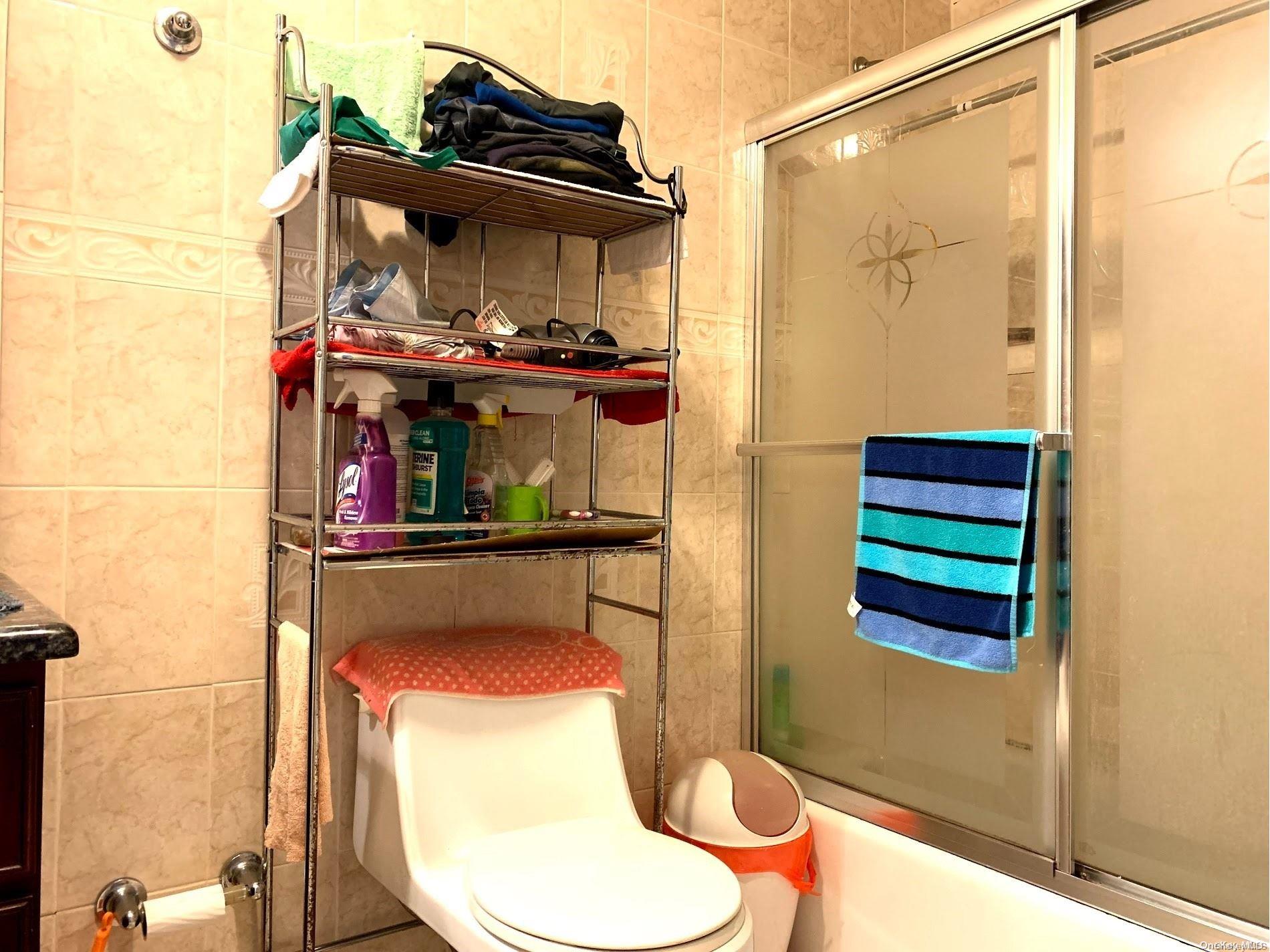 108-13 37th Avenue Queens, NY 11368 - Photo 16 of 23 a bathroom with a toilet and a shower
