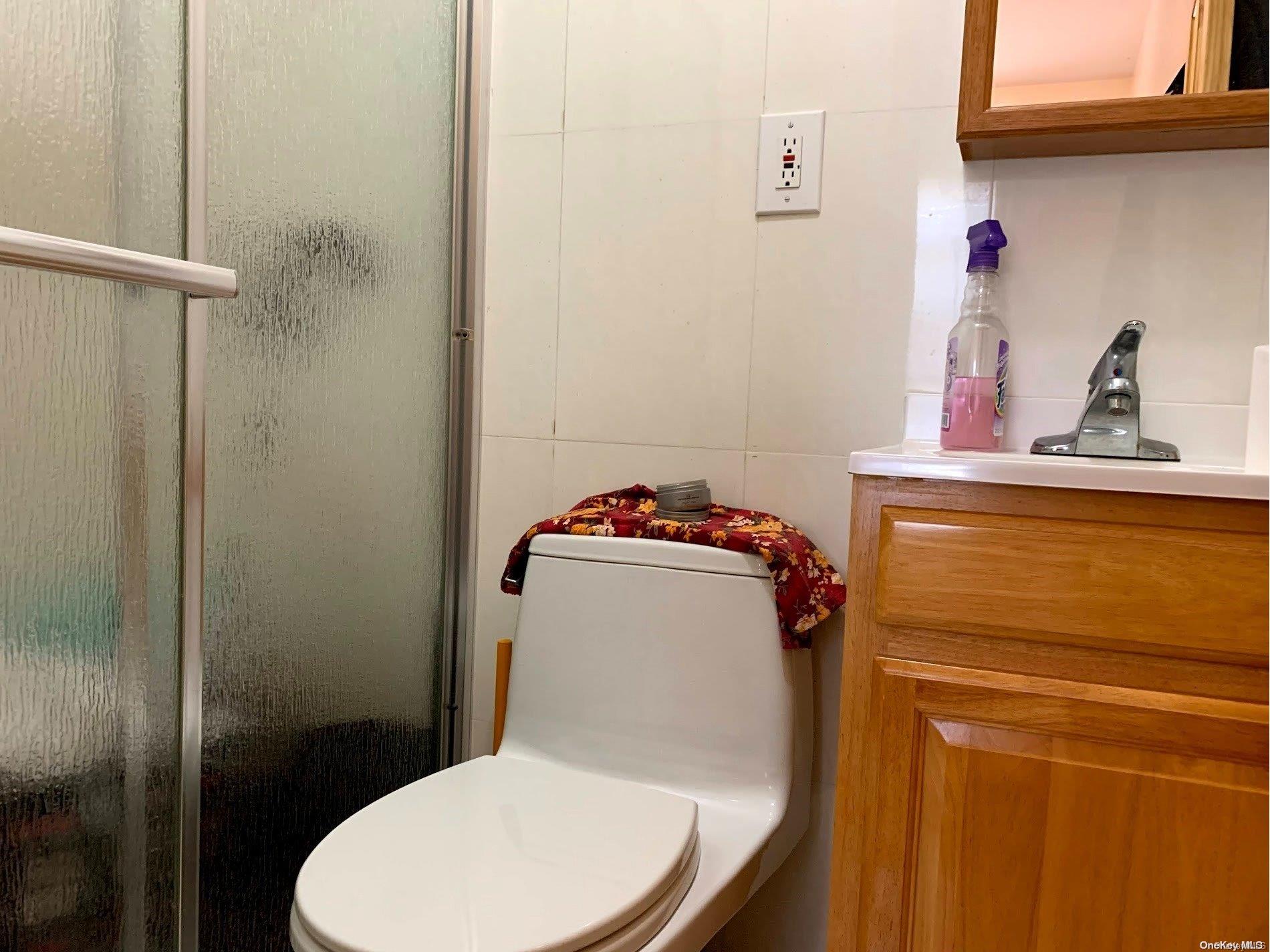 108-13 37th Avenue Queens, NY 11368 - Photo 18 of 23 a bathroom with a toilet and a sink