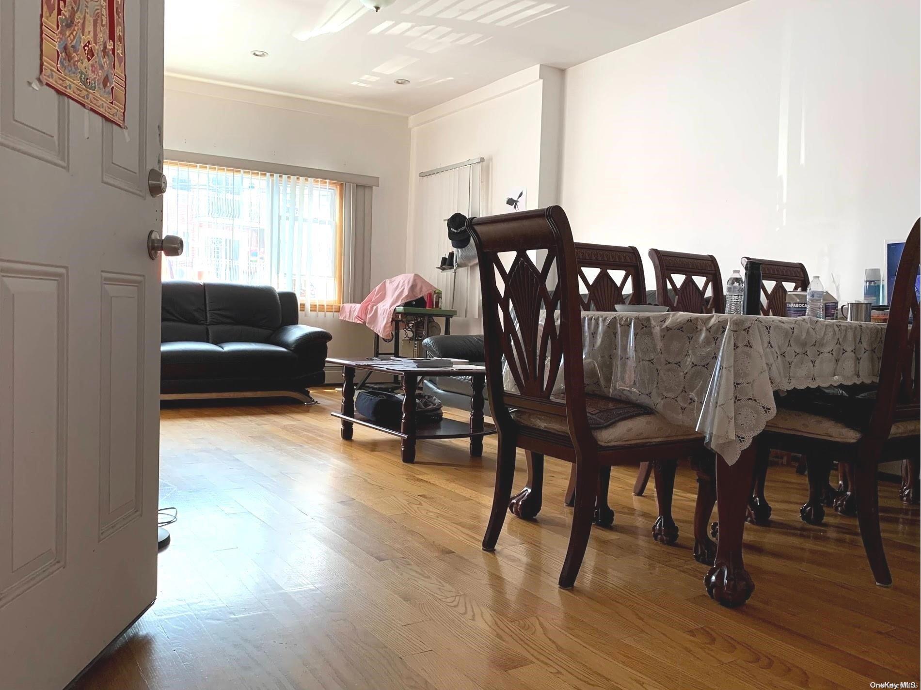 108-13 37th Avenue Queens, NY 11368 - Photo 20 of 23 a view of a dining room with furniture and wooden floor