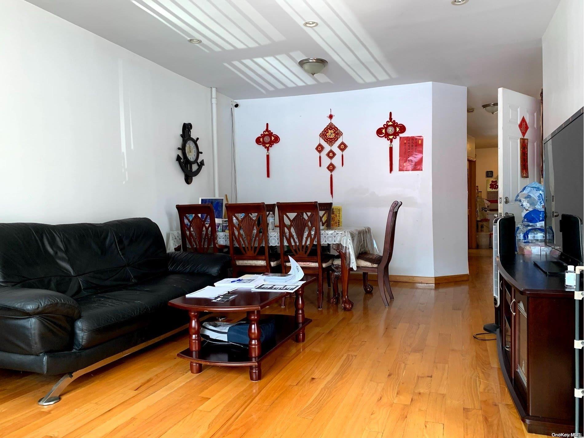 108-13 37th Avenue Queens, NY 11368 - Photo 2 of 23 a living room with furniture and wooden floor