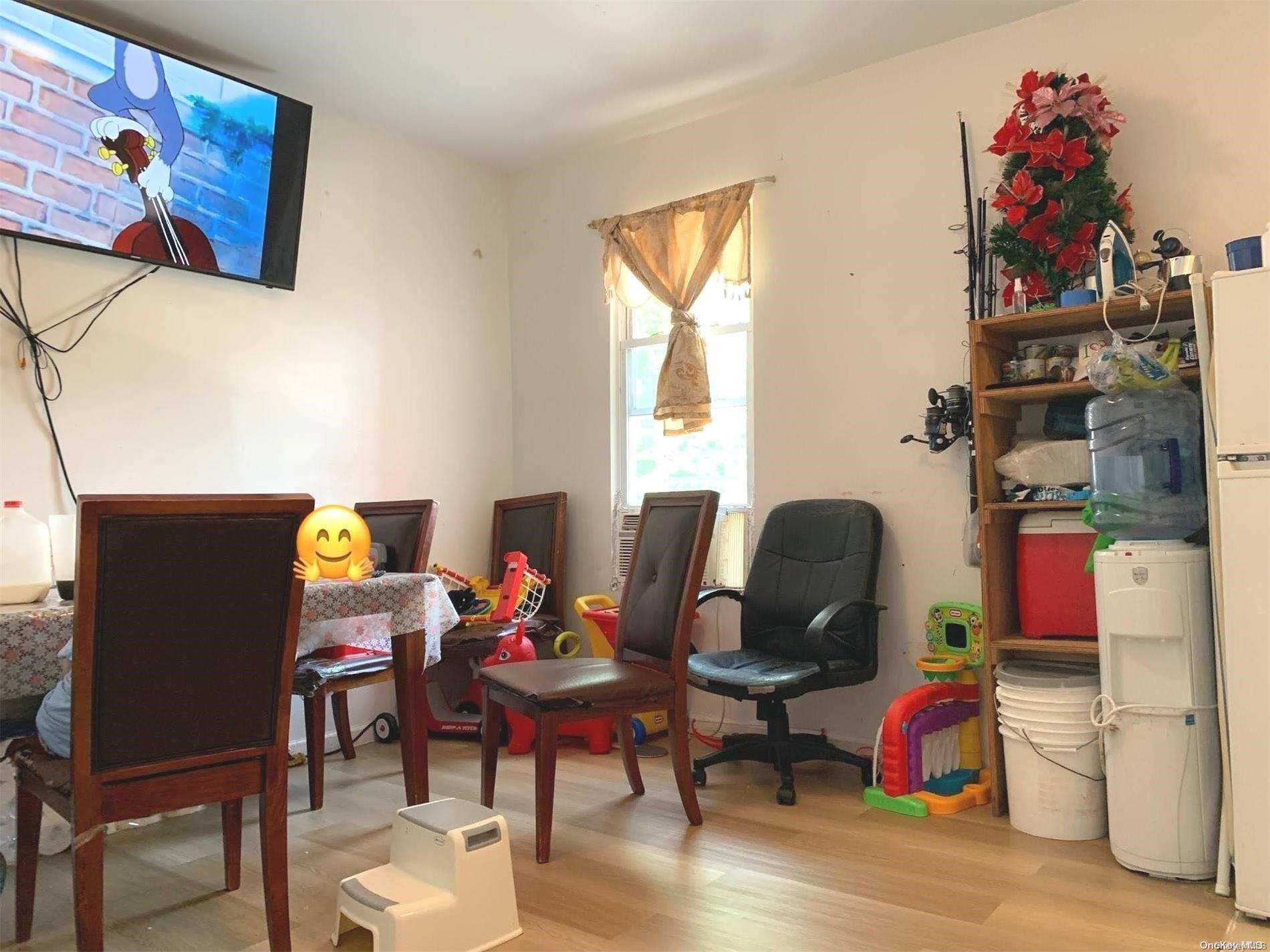 108-13 37th Avenue Queens, NY 11368 - Photo 21 of 23 a living room with furniture and a window
