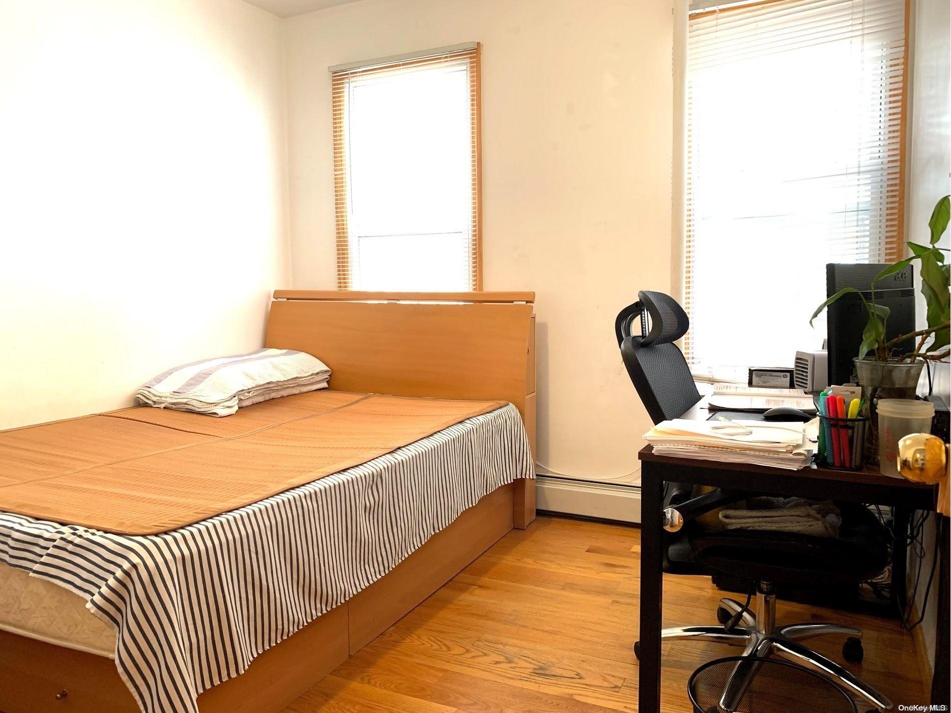 108-13 37th Avenue Queens, NY 11368 - Photo 4 of 23 a bedroom with a bed and a window