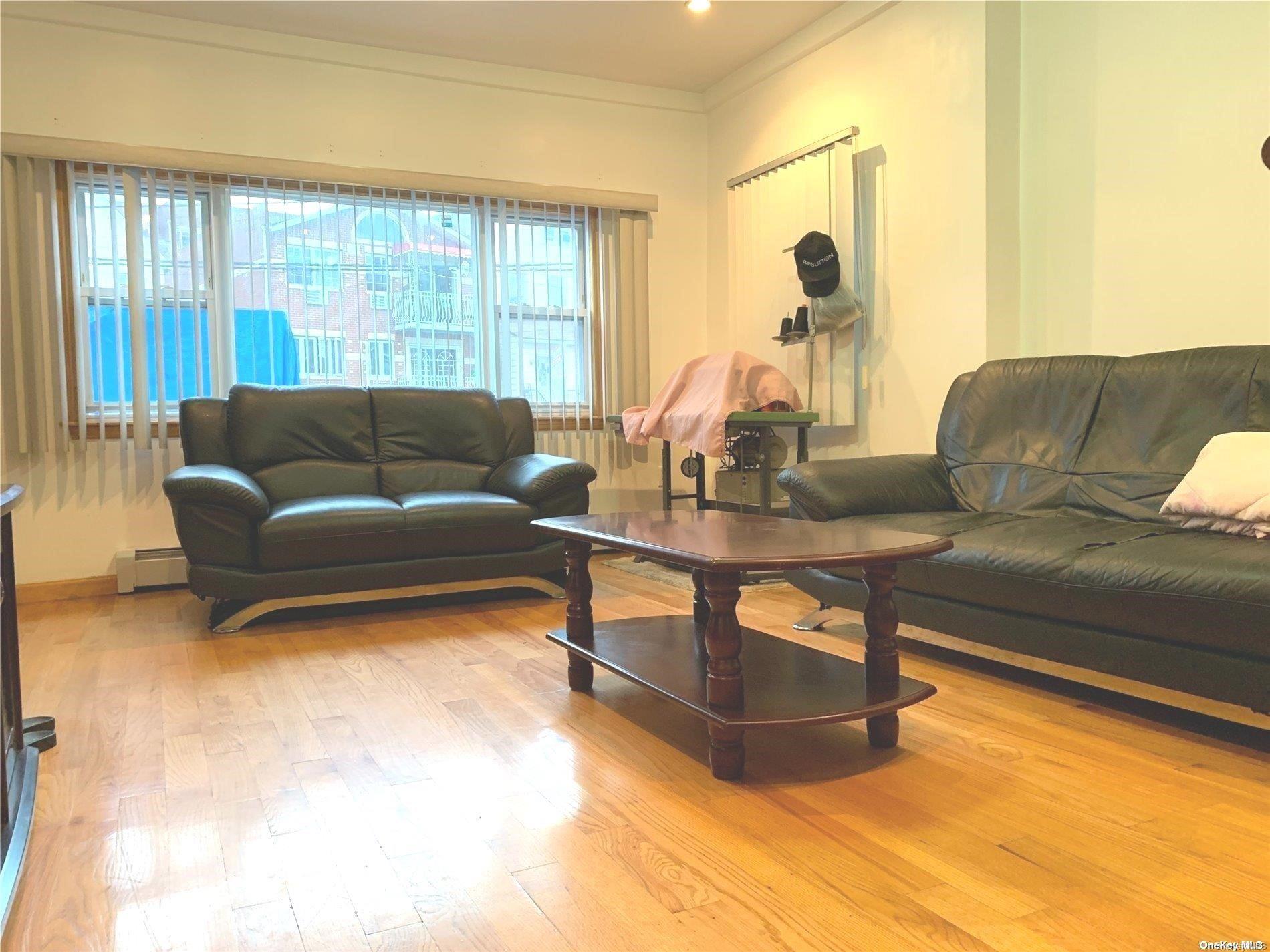 108-13 37th Avenue Queens, NY 11368 - Photo 5 of 23 a living room with furniture and a large window