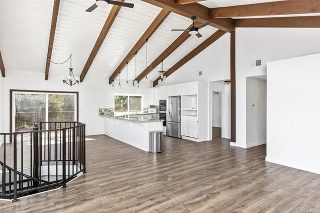 a kitchen with stainless steel appliances granite countertop a sink and a refrigerator