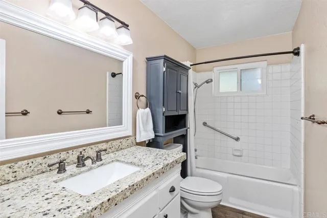 a view of a livingroom with a ceiling fan and window