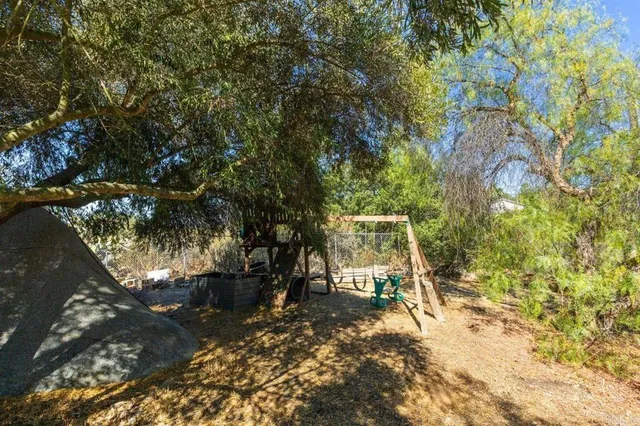 a front view of a house with a yard and balcony