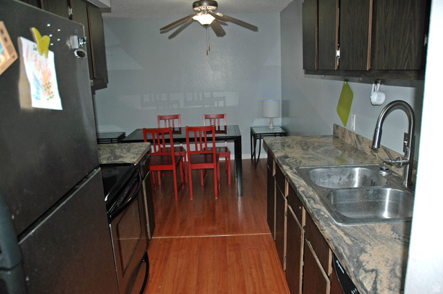 46 Lester Avenue, Unit G 24 Murray, UT 84107 - Photo 7 of 16 Kitchen and dining area featuring wood-finish flooring